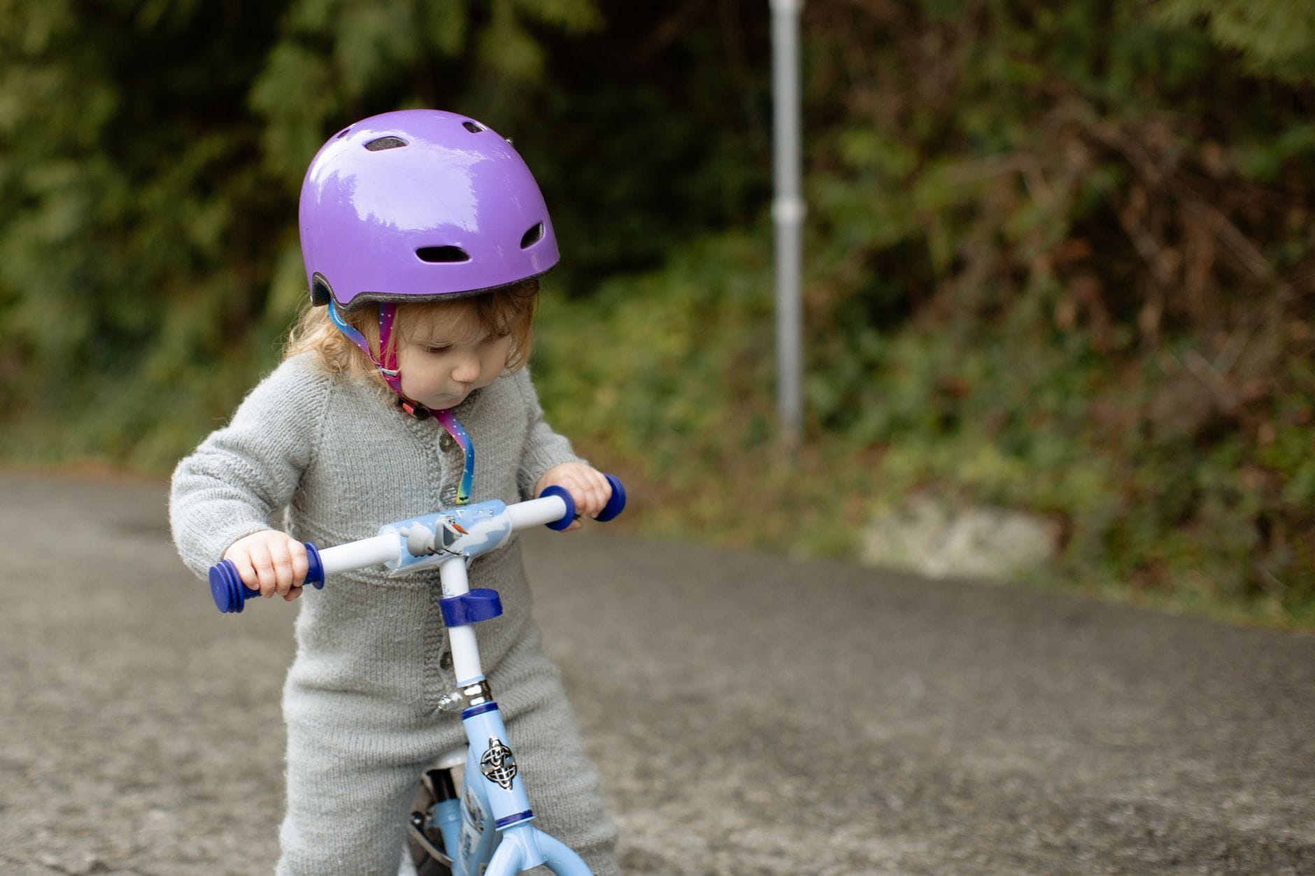 Kask rowerowy dla przedszkolaka: jak dobrać rozmiar i uniknąć typowych błędów Maluch w kasku rowerowym bawi się rowerkiem na wiejskiej drodze